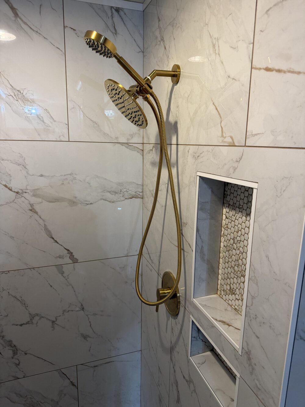 Luxury gold shower system on marble tile